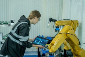 Engenheira usando tablet para controlar mão robótica